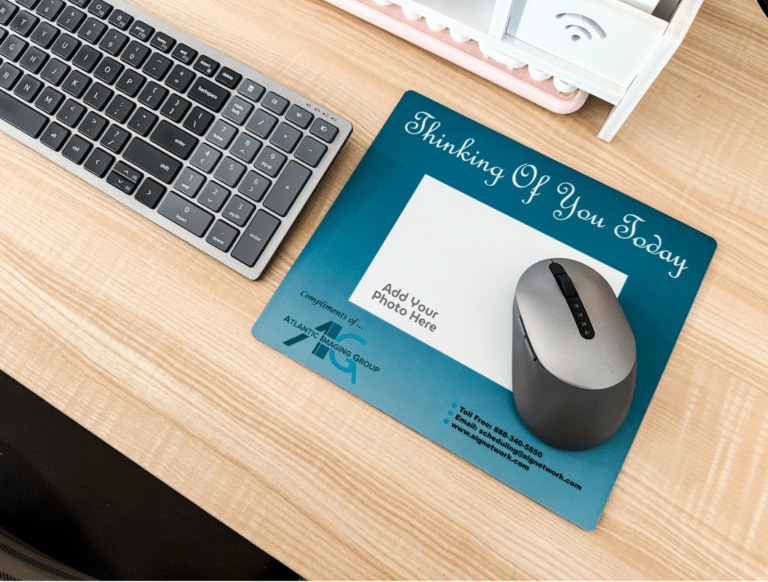 Photo of a window insert mouse pad at a desk.